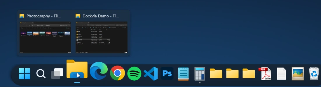 The File Explorer Dock icon enlarged under the pointer, with its window previews open above it